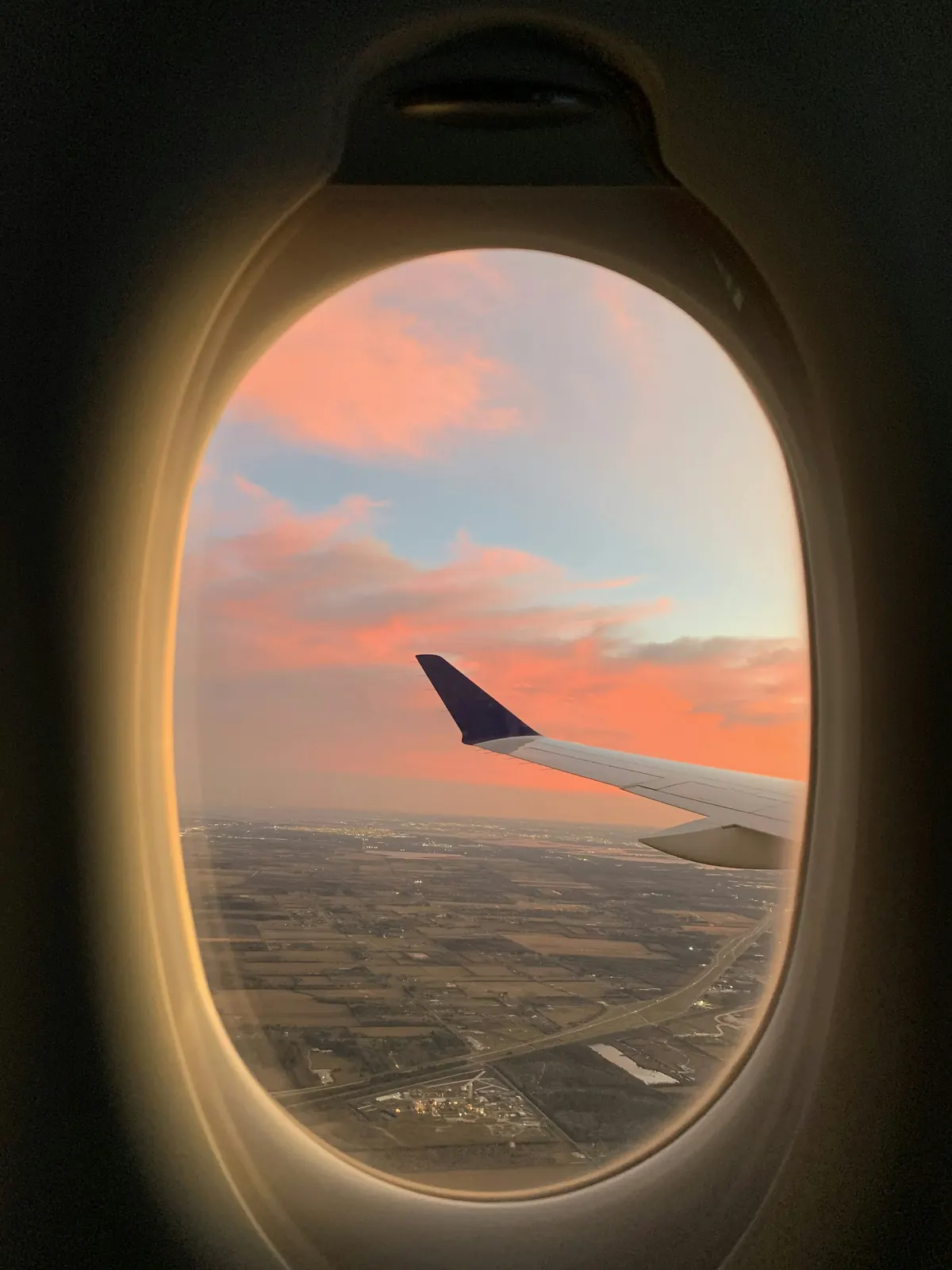 Aircraft window at sunset